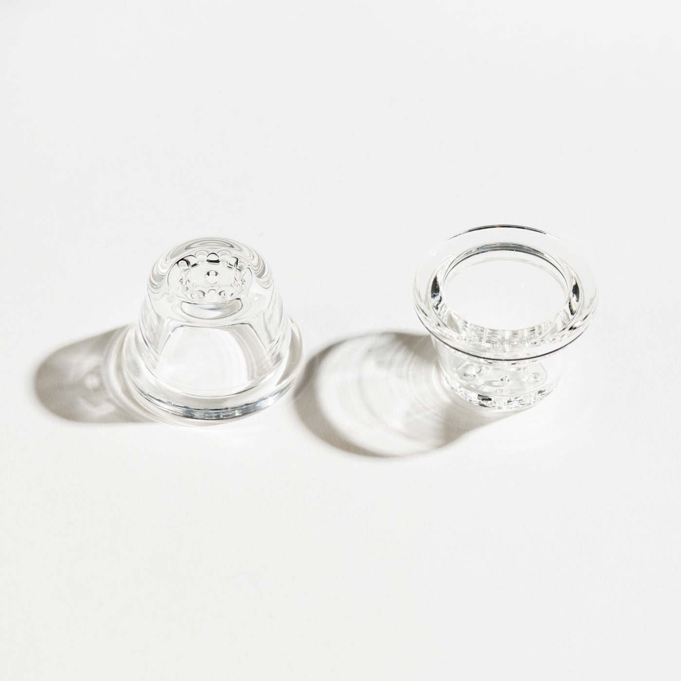 two 9-hole glass pipe bowls in a white background upside down