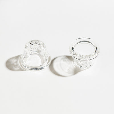 two 9-hole glass pipe bowls in a white background upside down