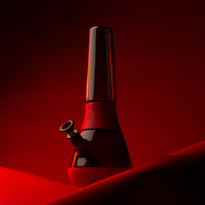 black glass bong with red cover against red background