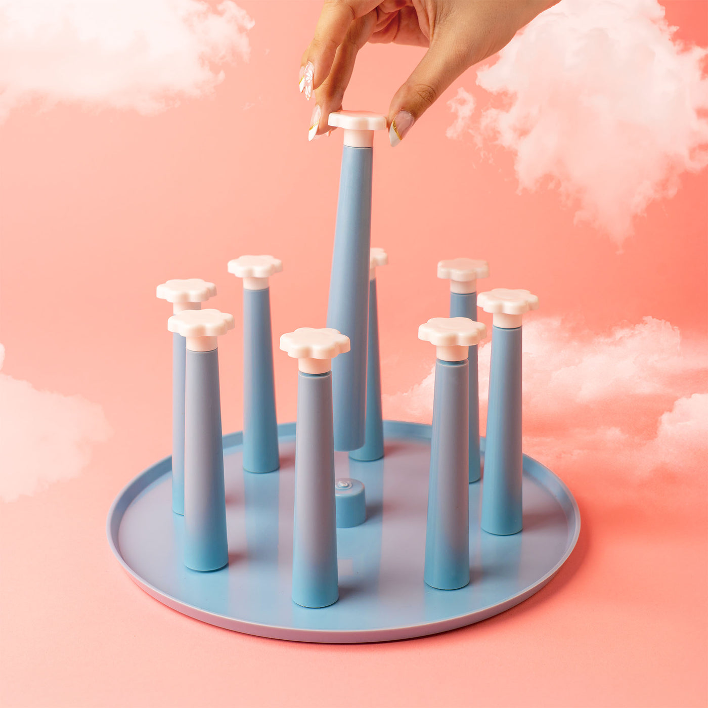 blue drying rack against pink background with clouds