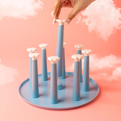 blue drying rack against pink background with clouds