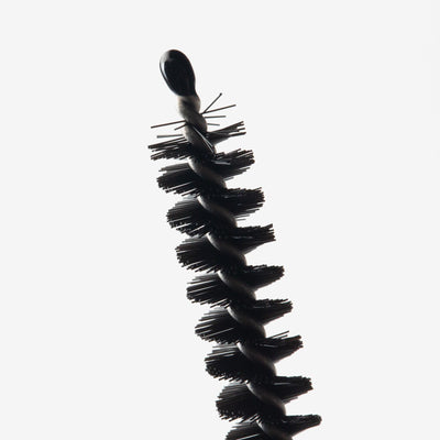 Close-up of a nylon cleaning brush with a protective rubberized tip, designed for cleaning bong down stems and small components