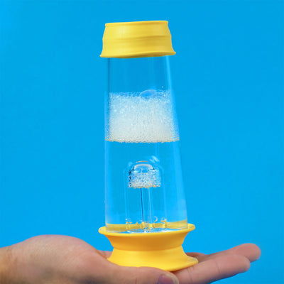 Hand holding bong Percolator with bubble water inside and yellow cleaning cap on top and bottom, blue background 