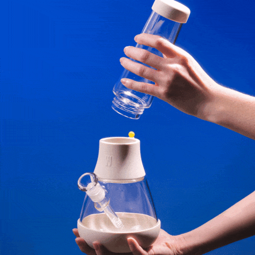 A person detaching the Weeday modular bong and washing it with a sponge.