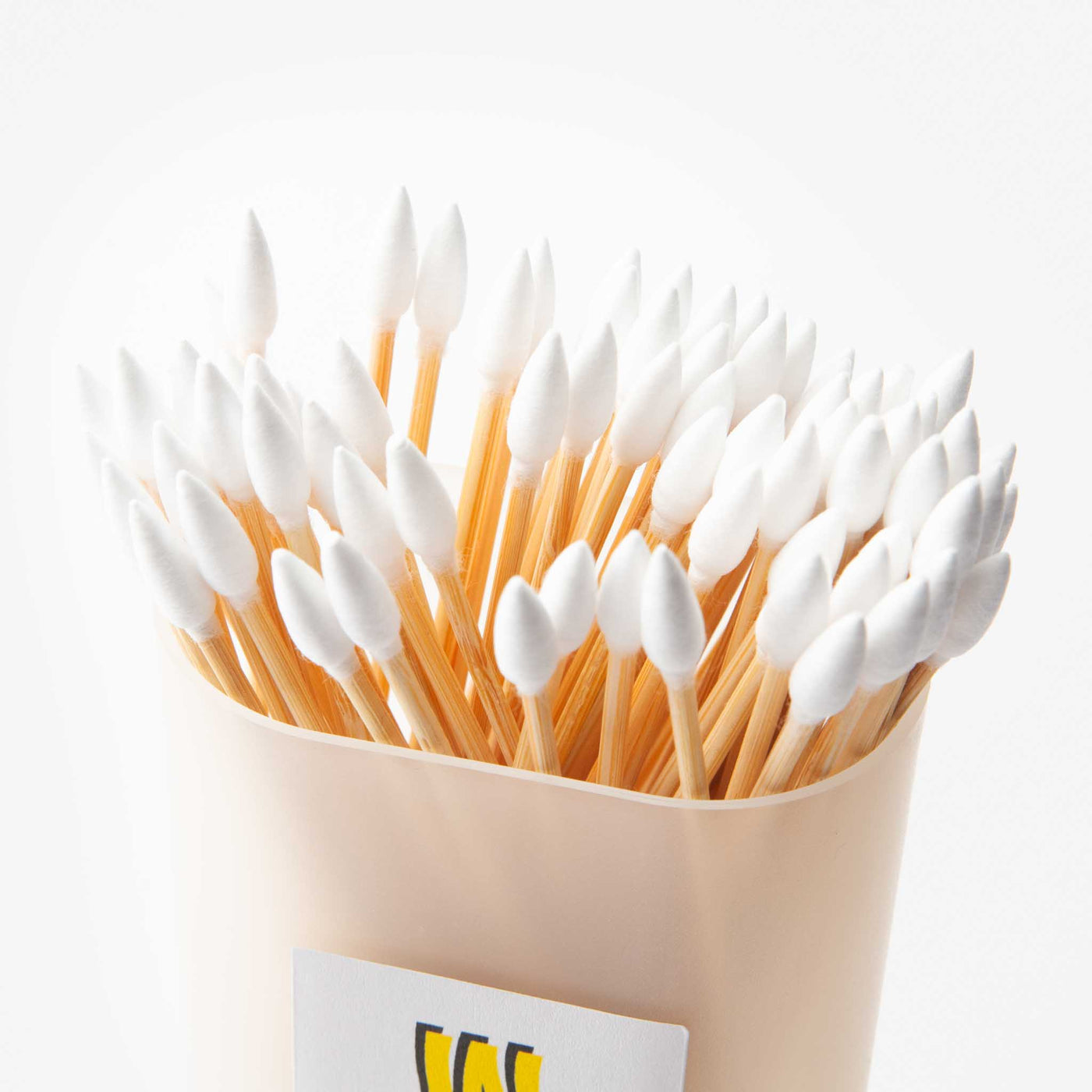 Close-up of a pack of 80 cleaning swabs with pointed cotton tips and bamboo sticks, neatly arranged in a transparent box.