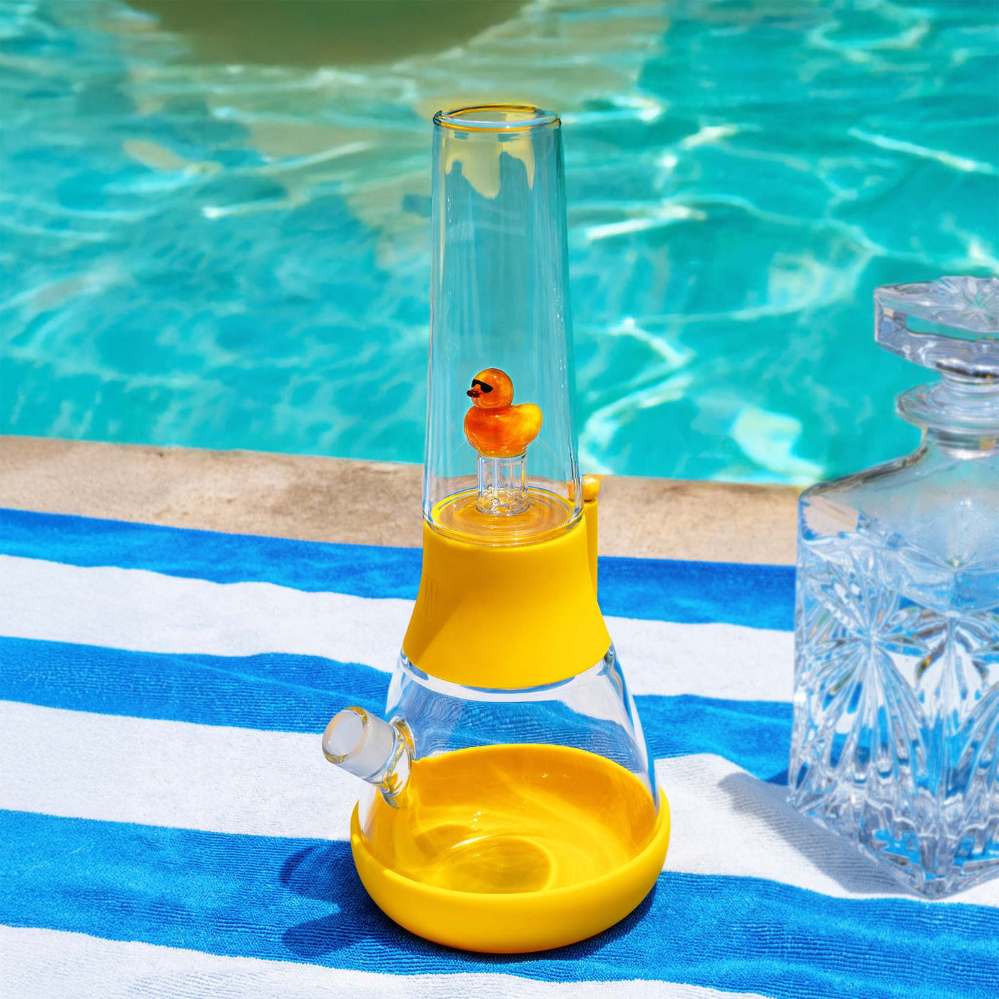 duck percolator bong poolside on a towel 
