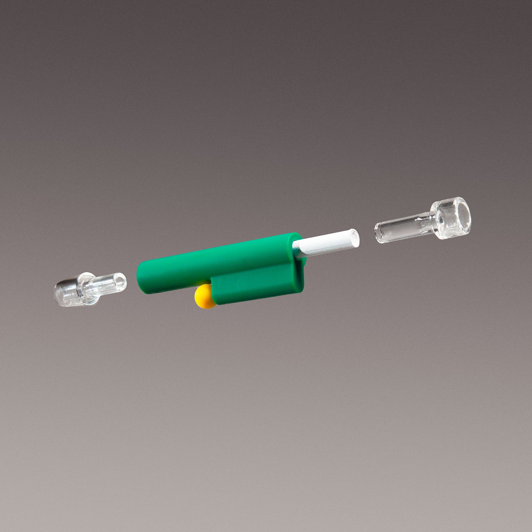 Exploded view of the green one-hitter pipe, featuring glass parts, silicone body, poker, and 6mm filter against a neutral background.