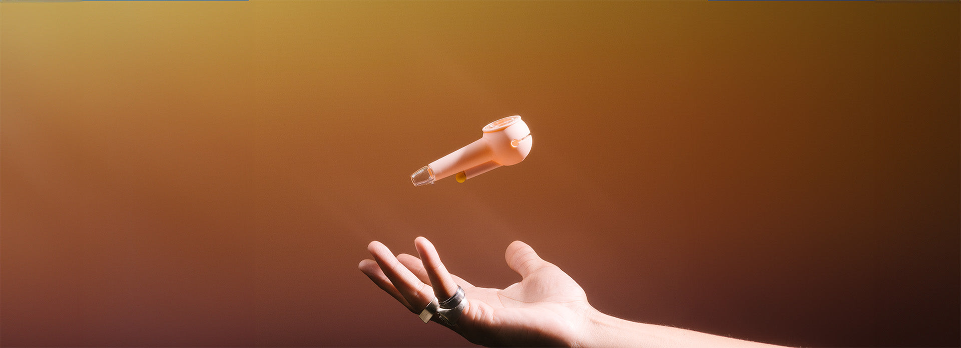 A hand magically lifting a weeday modular pipe, seemingly floating in the air against an orange gradient background.