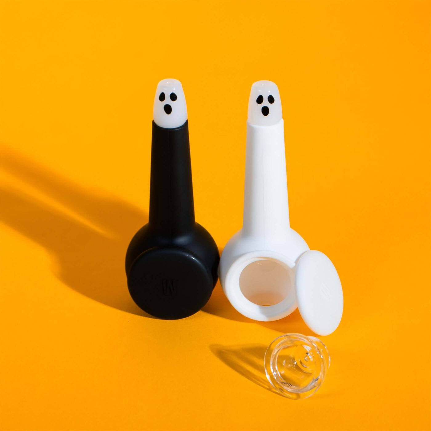 Black and white ghost pipes with clear pipe bowl and yellow backdrop 