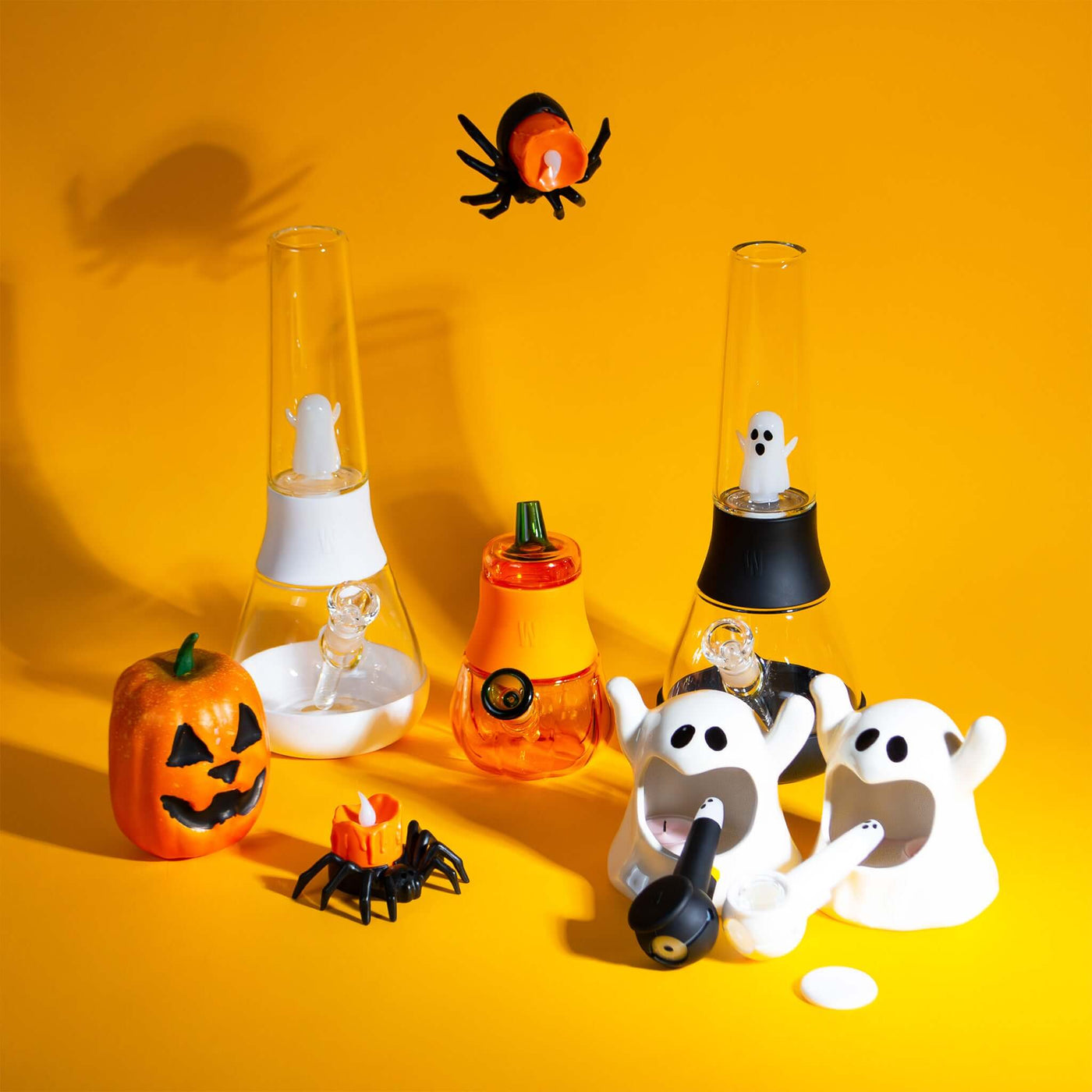 Halloween edition ghost percolator Bong, bubblers, and pipe family collection, yellow backdrop with pumpkin 