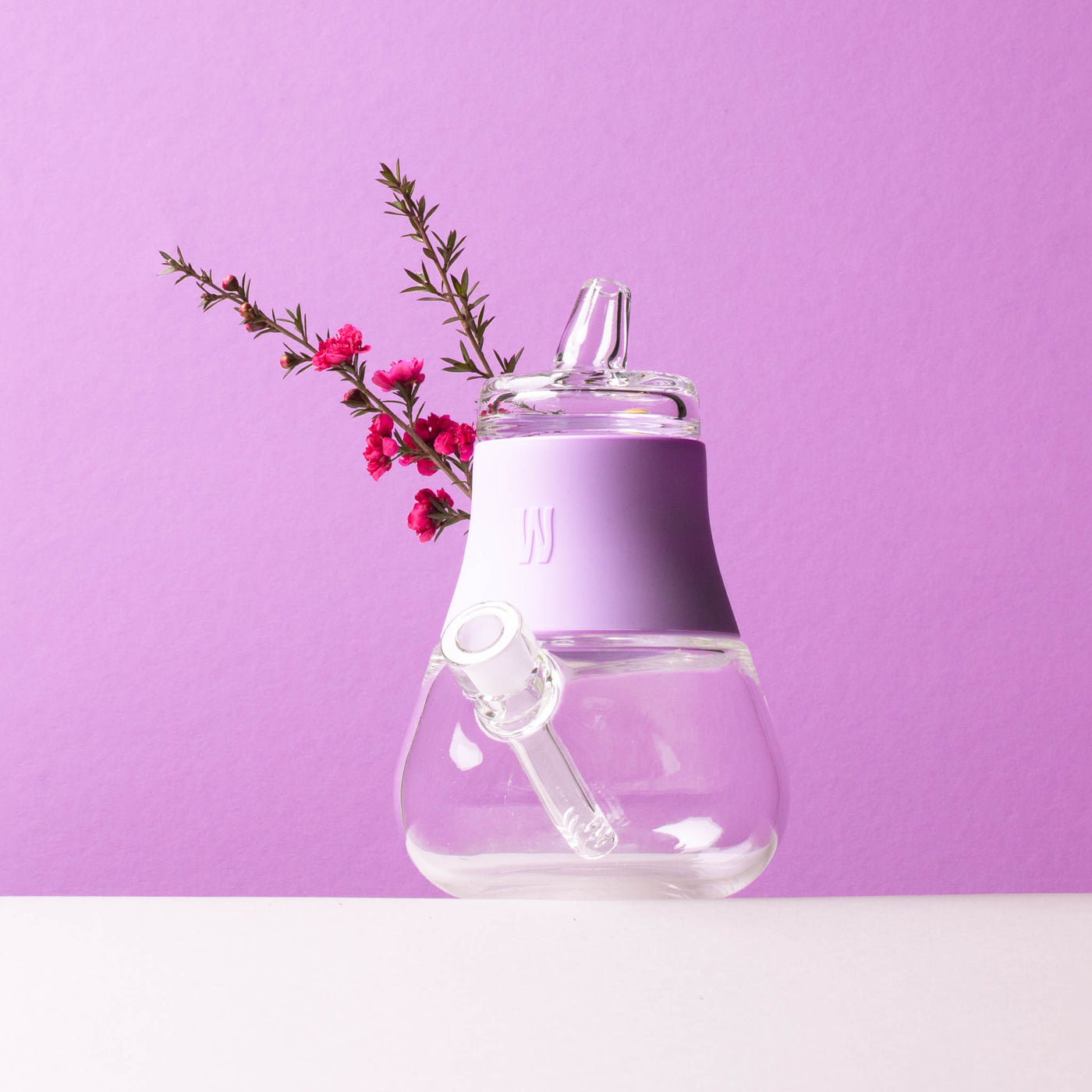 bubbler with clear glass and lavender cover with lavender plant 