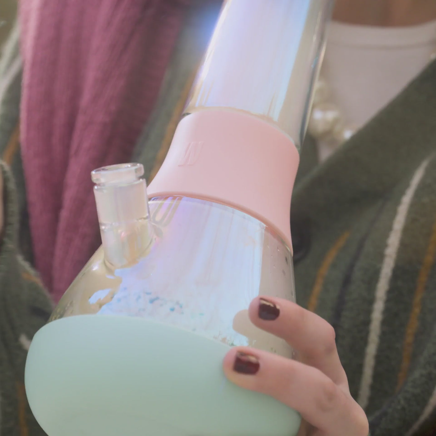 Model smoking with iridescent glass bong