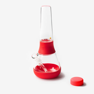 clear glass bong with red silicone covers against white background 