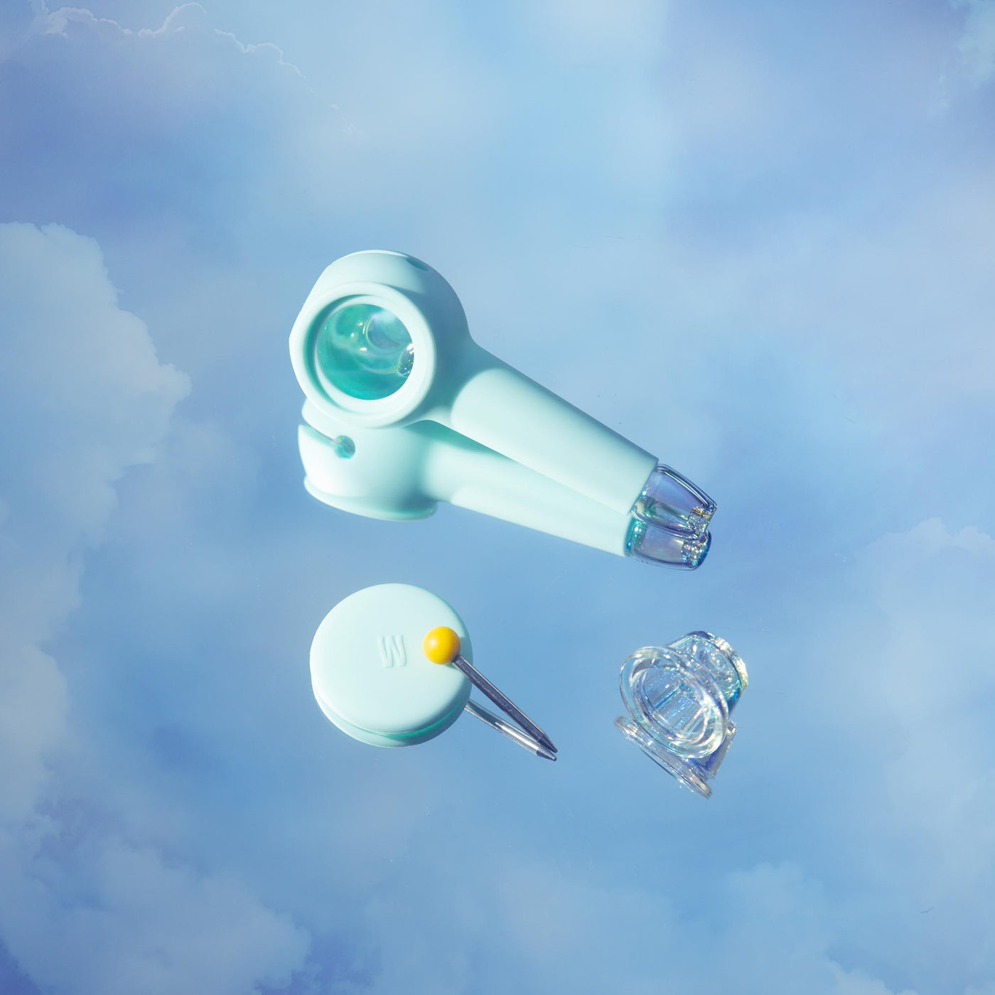 Sky blue iridescent hand pipe with detachable parts, displayed against a dreamy cloud background for a minimalist, dreamy look.