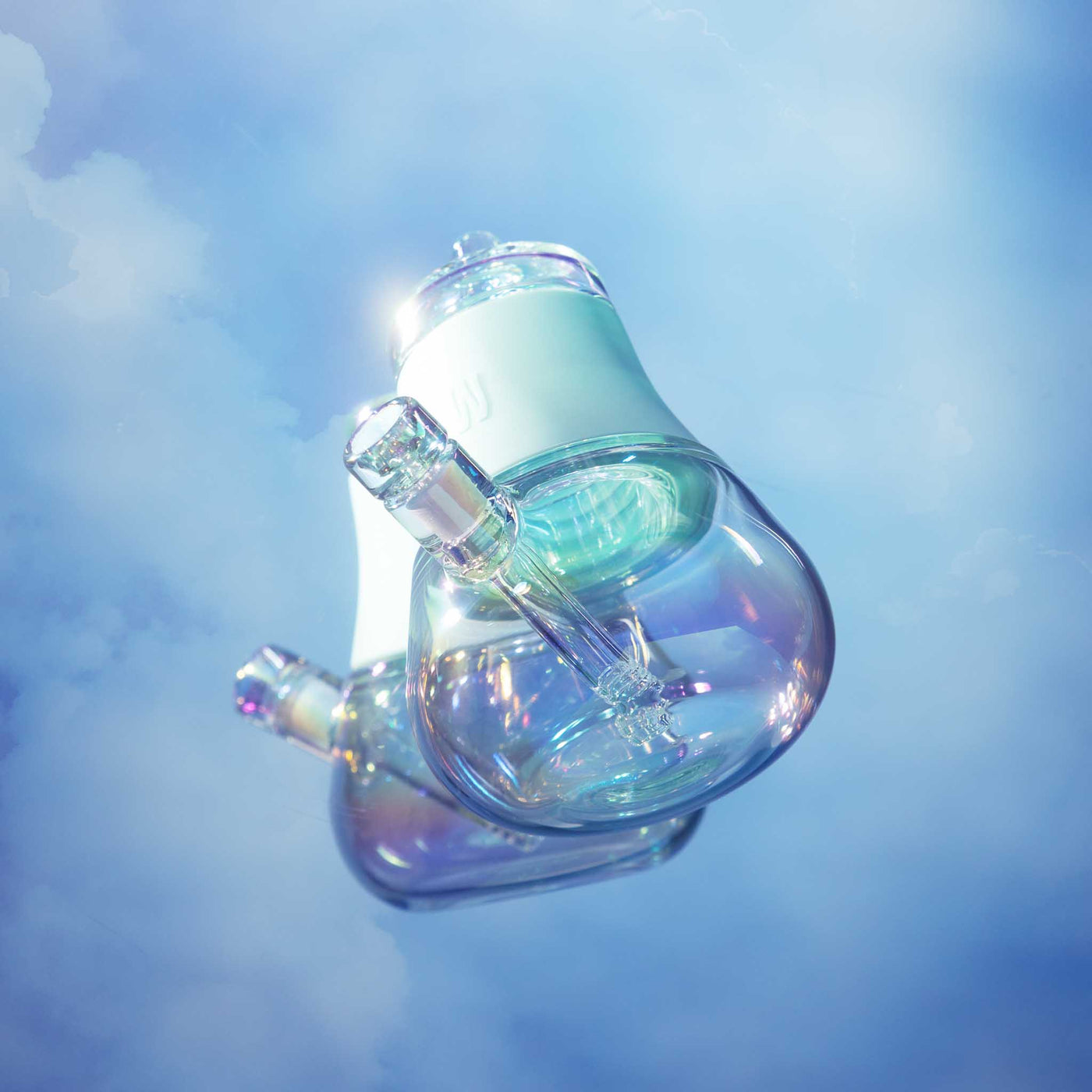 Sky blue iridescent glass bubbler with a silicone grip, showcasing a radiant reflection, floating against a cloudy sky backdrop.