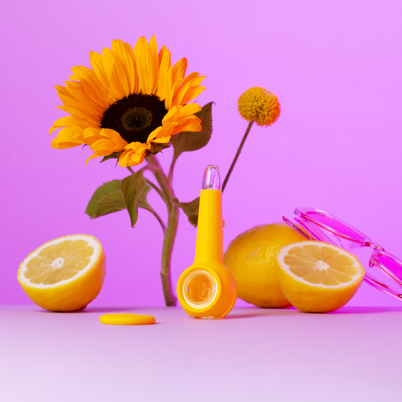 sunshine yellow pipe with sunflowers and lemons against a purple background. 