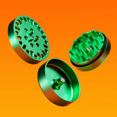 3 piece metal grinder detached view against orange background