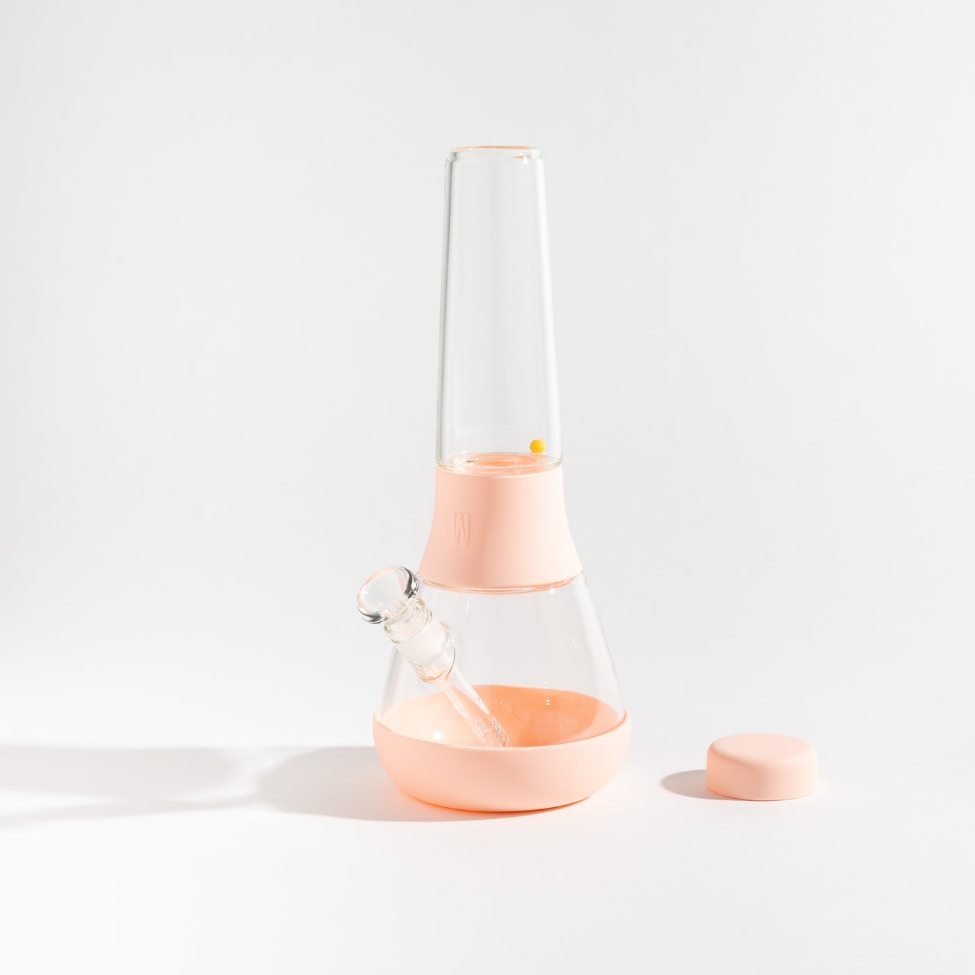 Detachable glass bong with bubblegum pink silicone covers on a white background.
