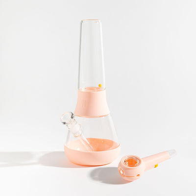 A bundle set of the Weeday modular glass bong and spoon pipe in bubblegum pink silicone covers on a white background.