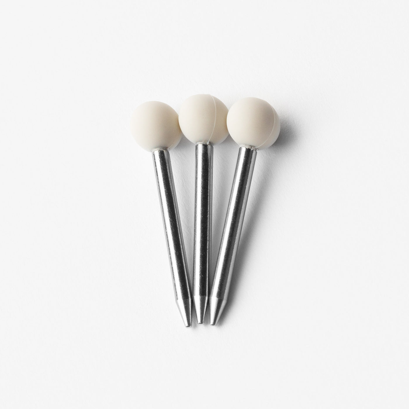 Cream white pokers in three, white background