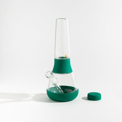 Detachable glass bong with forest green silicone covers on a white background.