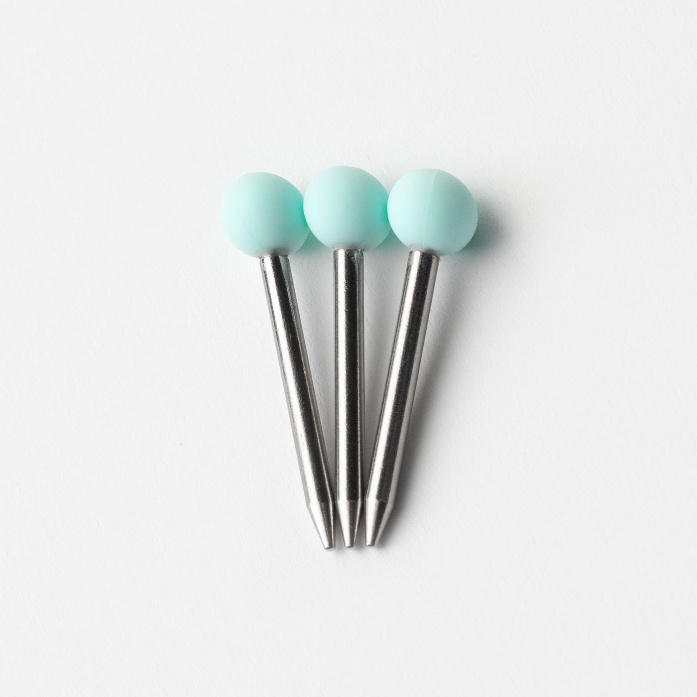 Sky blue pokers in three, white background