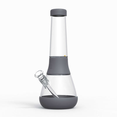 A designer glass bong with protective silicone covers in smoke gray.