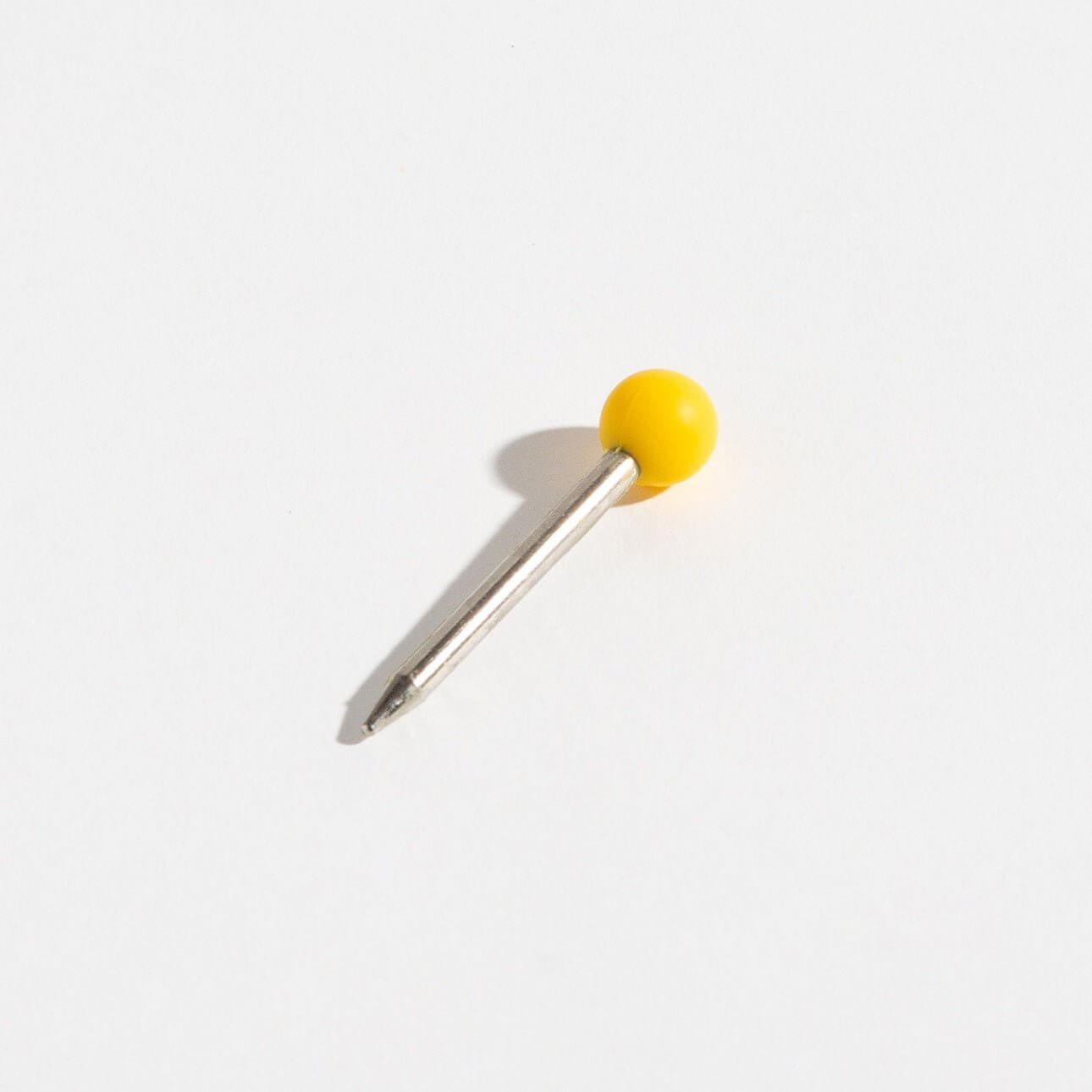 Weeday stainless steel poker with the yellow silicone head on a white background.